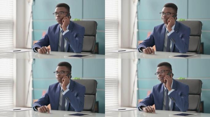 Young African Businessman Talking on Phone in Offi