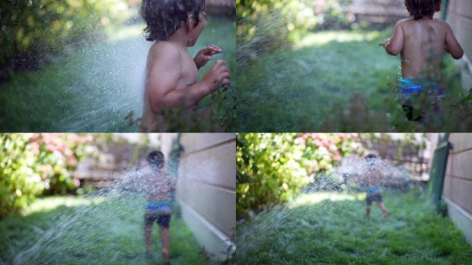 暑假期间，在小男孩外面享受假期跑步和大笑的水冲洗孩子