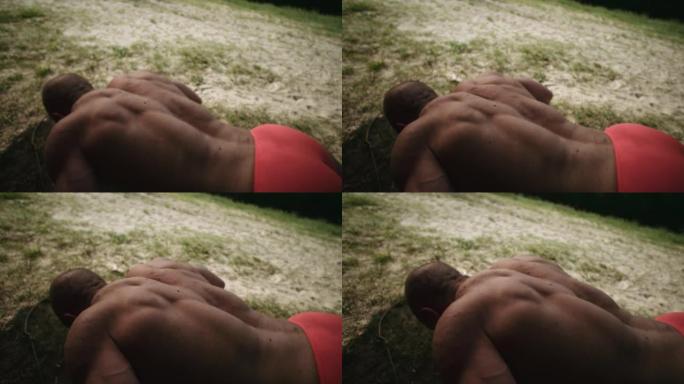 男子在日出时在公园锻炼时做俯卧撑