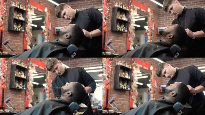 美发师用剪刀剪，用梳子梳客户的胡子。胡须护理