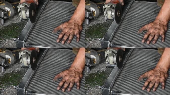 技术人员在车间使用磨石电动机床切割钢材