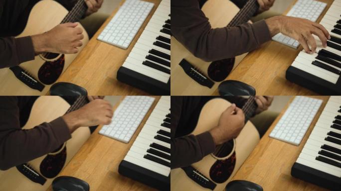 特写手专业歌曲作者用平板电脑弹奏钢琴键盘和吉他，用于混合和掌握音乐。男在录音室用音响设备创作歌曲。音