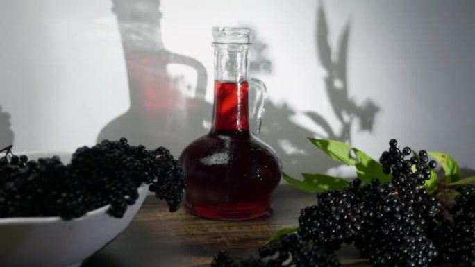 瓶红汁，接骨木香草酊，黑浆果特写。浆果制成的治疗饮料