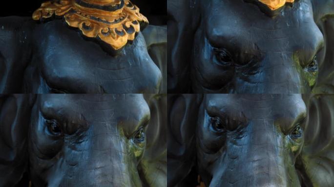 大象雕像脸部特写，皮肤上有蓝色和绿色阴影