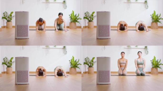 舒适的白色客厅空气净化器，用于过滤和清洁去除灰尘PM2.5 HEPA在家与女性在背景中锻炼瑜伽，为新