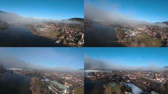 巴伐利亚湖冬季。无人机飞行4k。晴天有雾