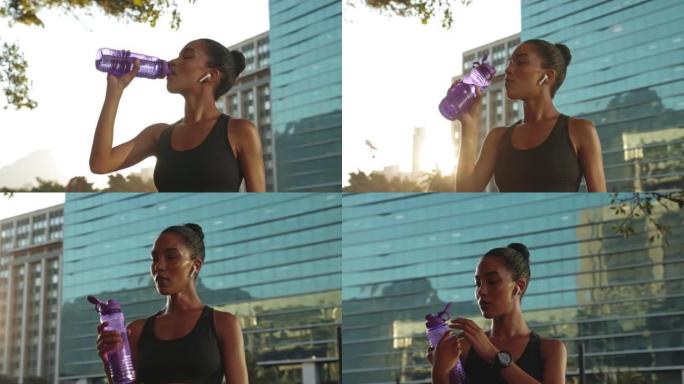 女运动员休息时喝水。活跃的女人从瓶子里喝水。混血运动员用瓶子喝水
