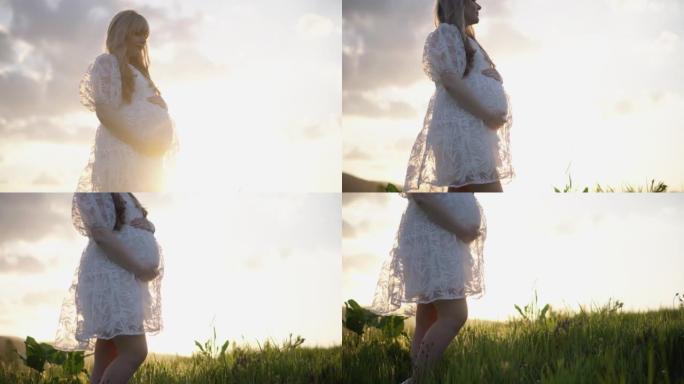 一个年轻的怀孕女孩在夏天在大自然中行走。一个穿白色连衣裙的女人。一名孕妇正在等待孩子的出生。未来的年
