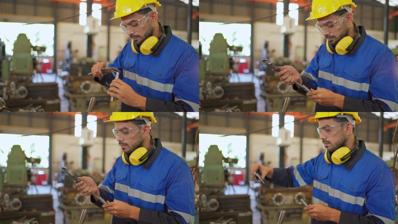 工厂工程师使用游标卡尺测量钢管。检查或维护机器。工作时戴安全帽和眼镜。工人检查员设备。工业和技术