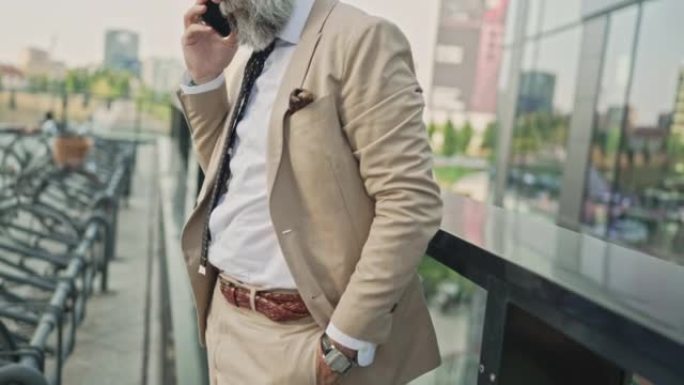 Mature businessman talking on the phone in busines