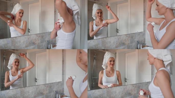 白人妇女用毛巾在头发上涂抹止汗剂。用8k的红氦相机拍摄。