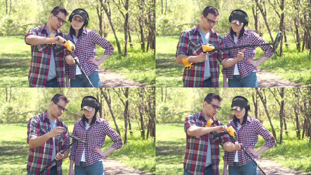 穿衬衫的男人寻宝者向穿衬衫的女孩解释如何在公园使用金属探测器