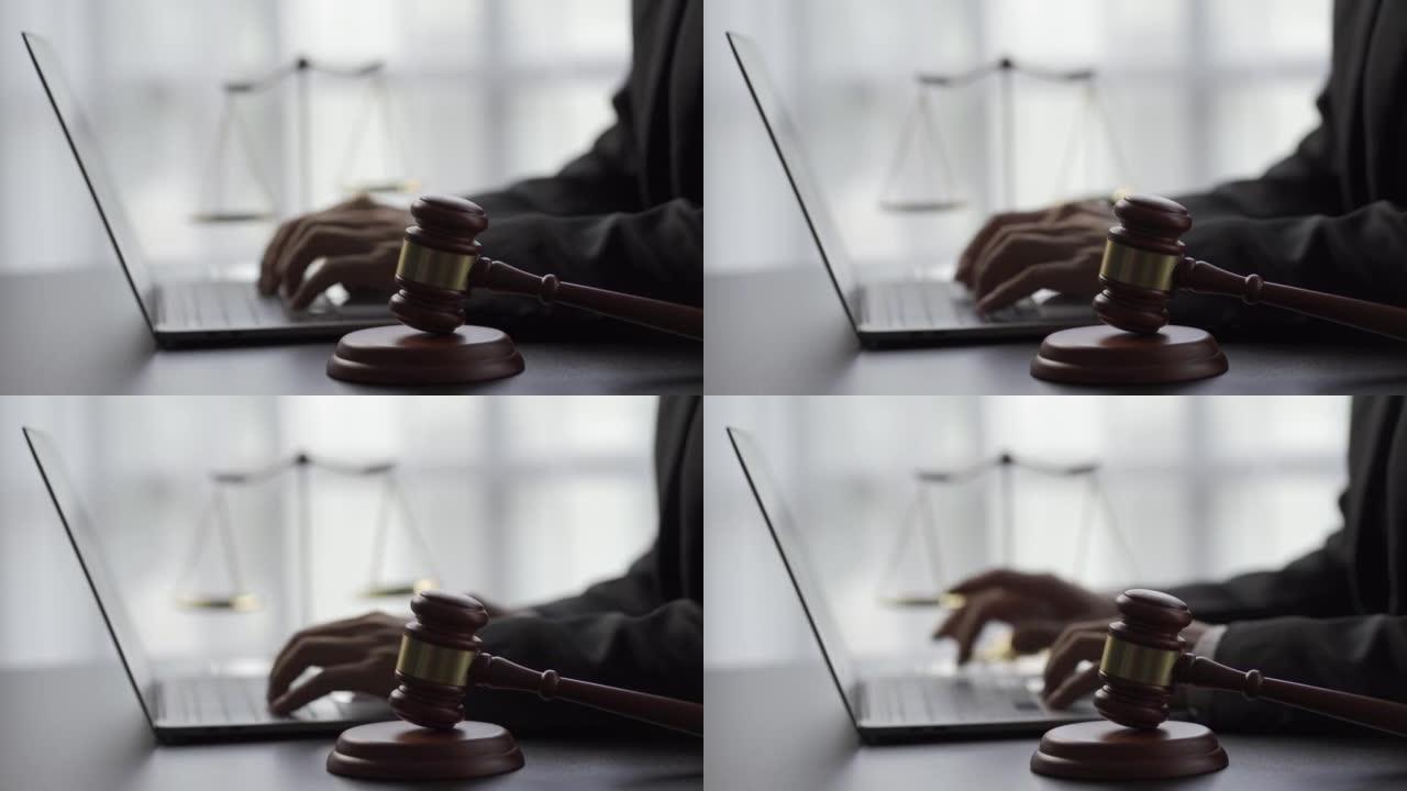 在线法律顾问概念法官的锤子和秤放在旁边。在后台的笔记本电脑上回答消息的律师