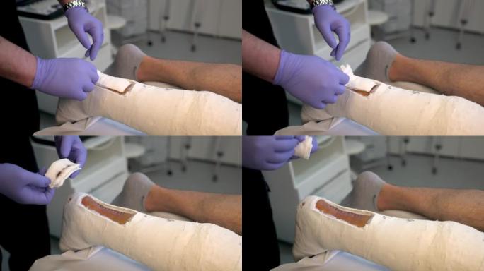 男性白种人骨科医生的B卷，将伤口包扎在青少年患者身上