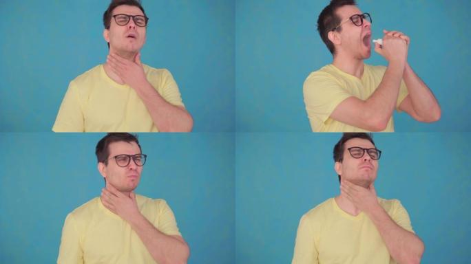 眼镜和t恤问题的中年男子肖像喉咙痛，用喷雾治疗喉咙蓝色隔离背景
