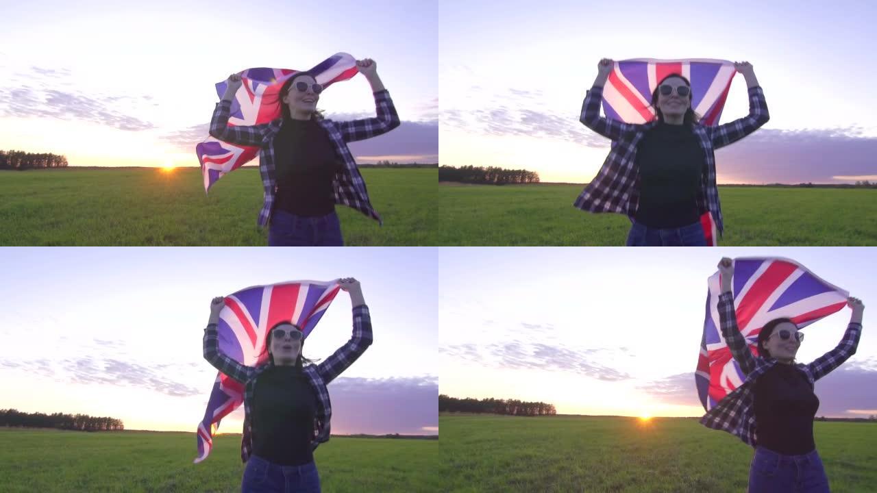 身穿衬衫和眼镜的年轻积极女性在日落时分带着英格兰的旗帜慢吞吞地穿过田野