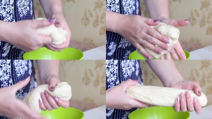 一个女人用手揉捏一团面团。准备花形式的甜甜圈。特写。