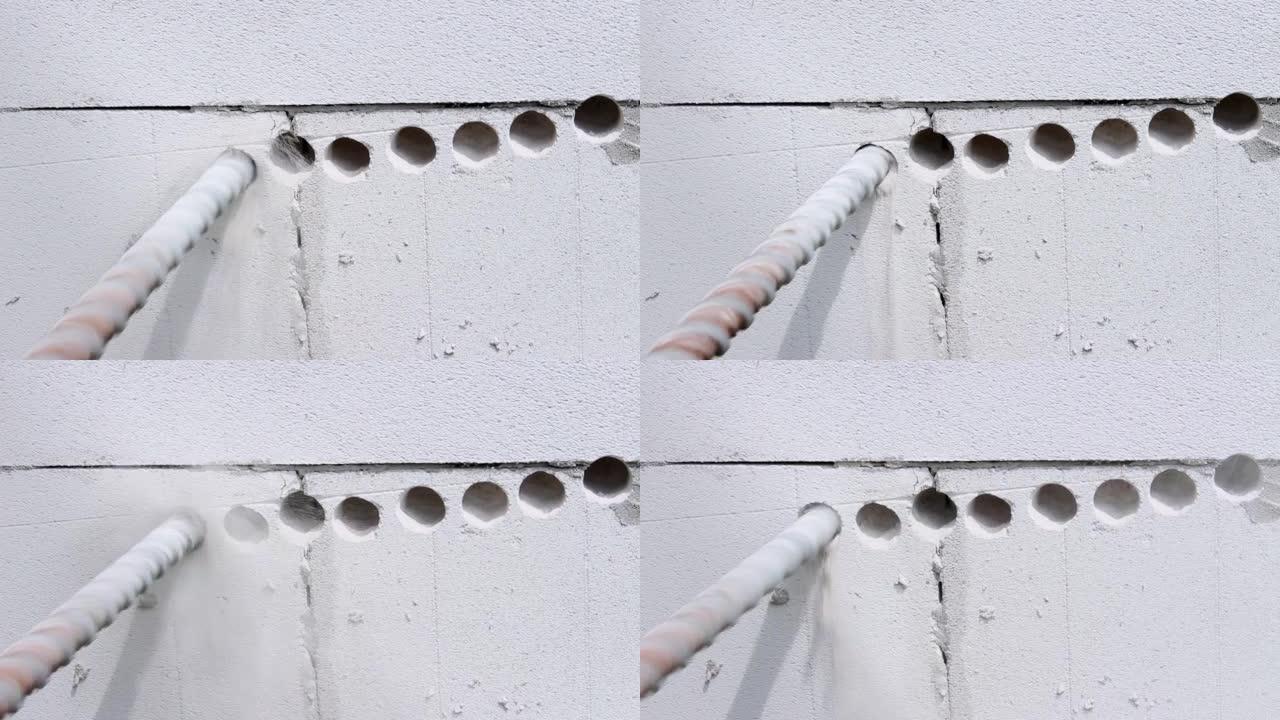 Builder使用穿孔器在墙壁上钻一个洞