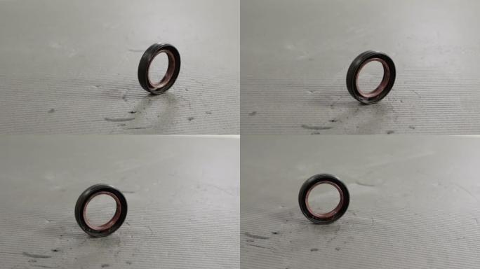 Camshaft oil seal in a car engine on a gray backgr