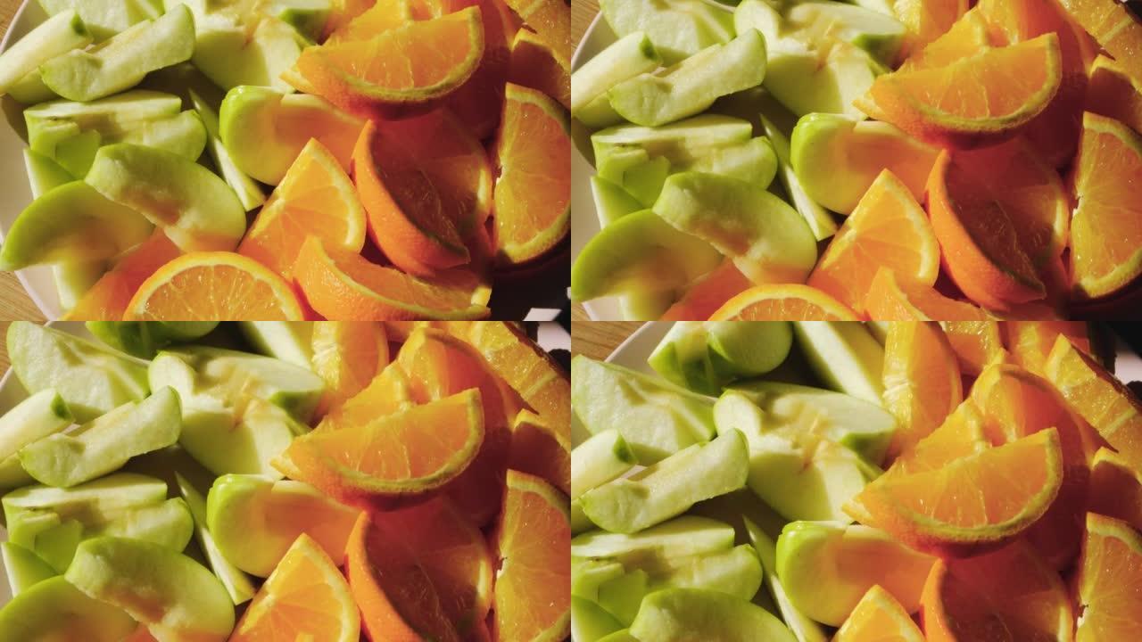 夏季水果盘，多汁的新鲜橘子和苹果切成薄片。