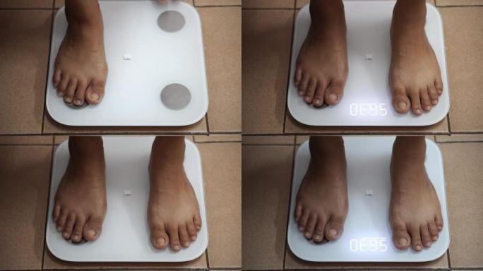 女人在数字秤上检查自己的体重