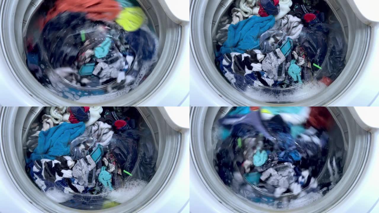 家用洗衣机洗衣服。旋转滚筒洗衣机的特写视频。高质量全高清镜头