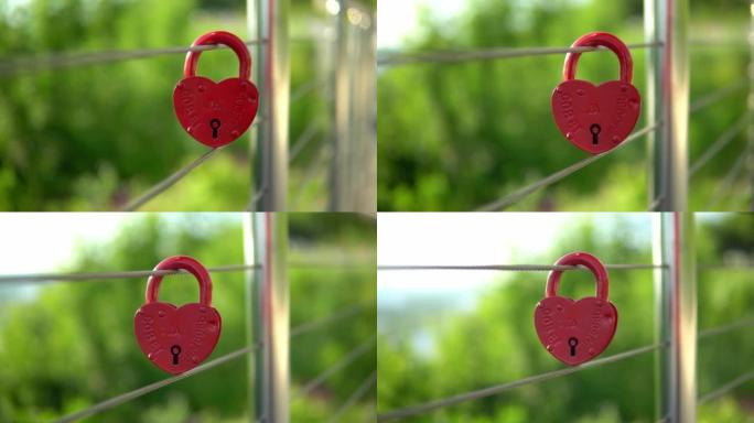 栏杆上挂着心形的红色婚礼锁。世界各地阻碍锁的婚礼传统。婚礼当天的纪念碑。锁上的铭文建议和爱