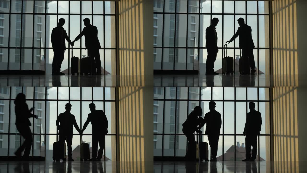 一名商人和女商人带着手提箱在一间巨大窗户的大办公室里行走的剪影。