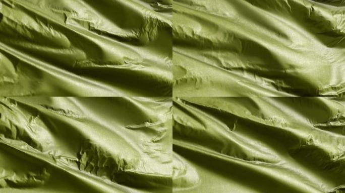 橄榄纺织织物在风背景上缓慢挥动。纯色色调。全填充慢动作无缝循环。
