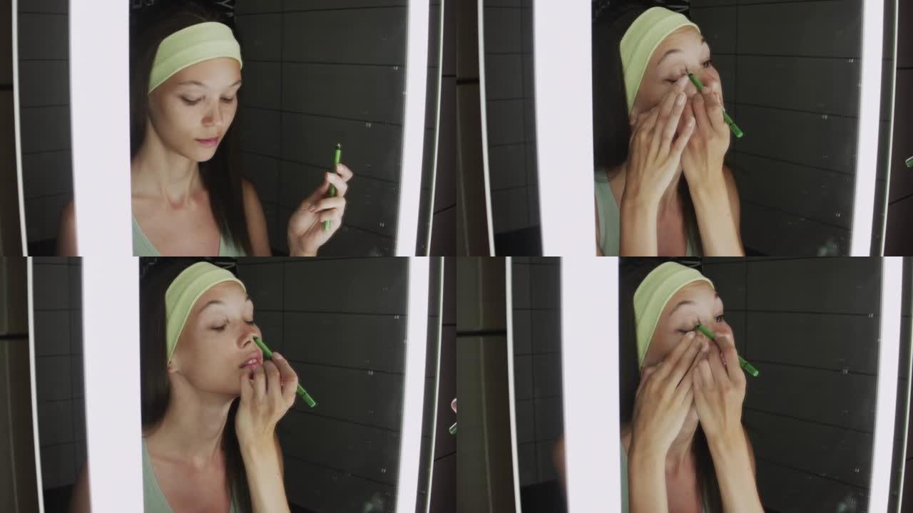 一个年轻女子早上站在浴室的镜子旁做日间化妆的特写镜头。