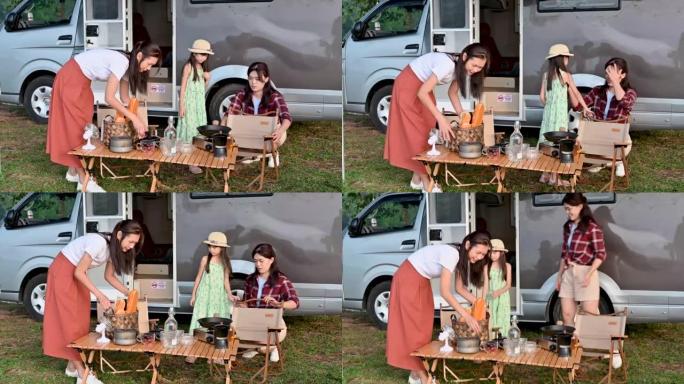 开朗快乐的多代亚洲家庭准备户外露营桌椅