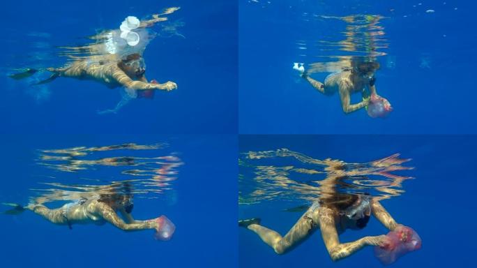 女人游泳并在水下收集塑料垃圾清理漂浮在海里的肮脏废弃塑料垃圾。女性浮潜者在水面下捕捉塑料垃圾。海洋的
