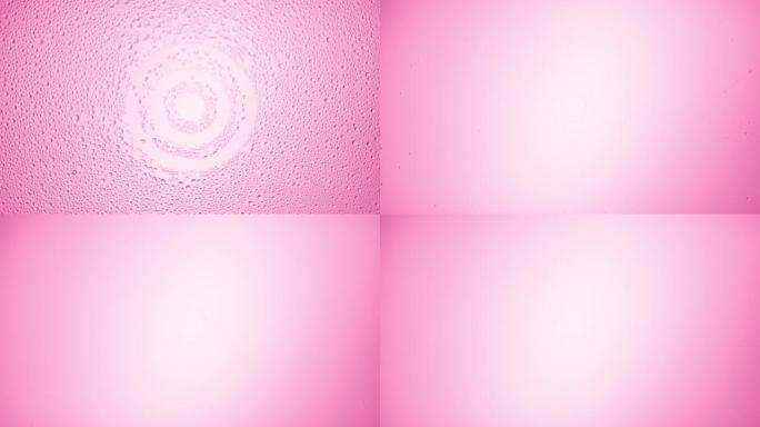 目标标志从粉红色背景的湿玻璃上吹下来