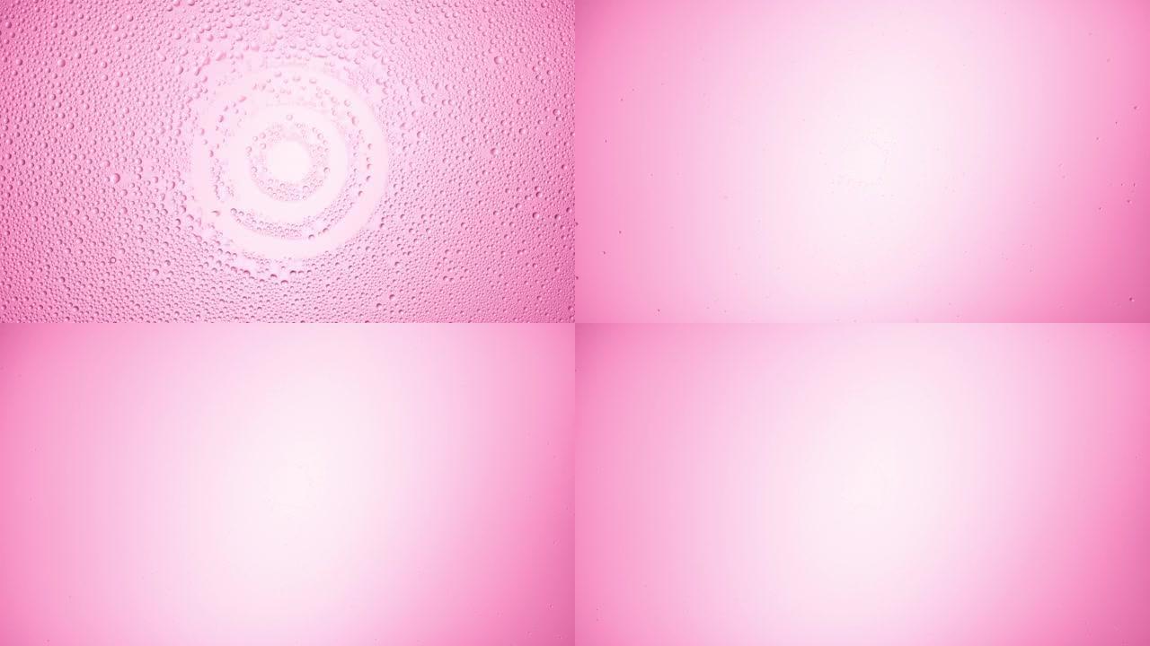 目标标志从粉红色背景的湿玻璃上吹下来