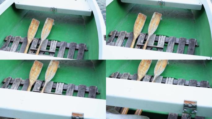 船桨躺在绿色的船上