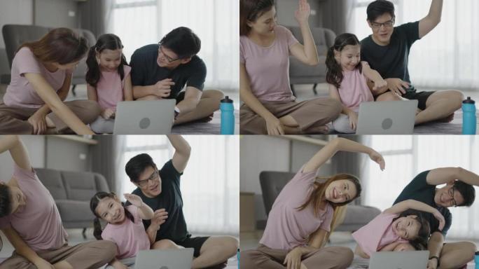 快乐的亚洲家庭在家里。父亲，母亲和可爱的女孩在平板电脑上观看视频摘录，然后同时将手臂扭到一边。健康生
