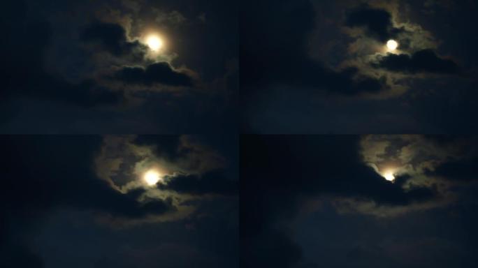 月亮在夜空中黑暗的戏剧性云层上的延时