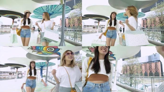 美丽的亚洲女孩在泰国曼谷快乐地带着Sopping bag行走。