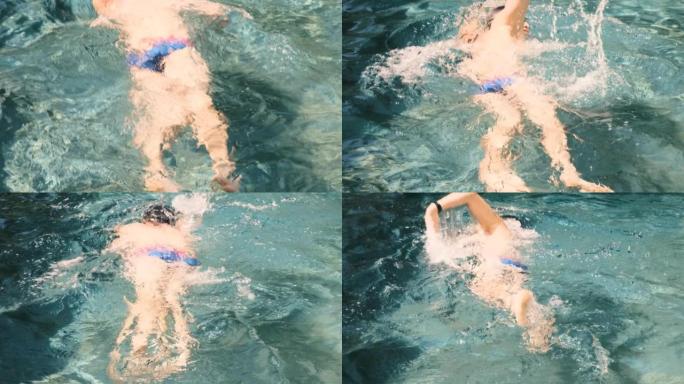 在湛蓝的海水中，从自由泳游泳运动员上方的特写镜头。职业运动员，比赛。健康的生活方式，运动，有氧运动。