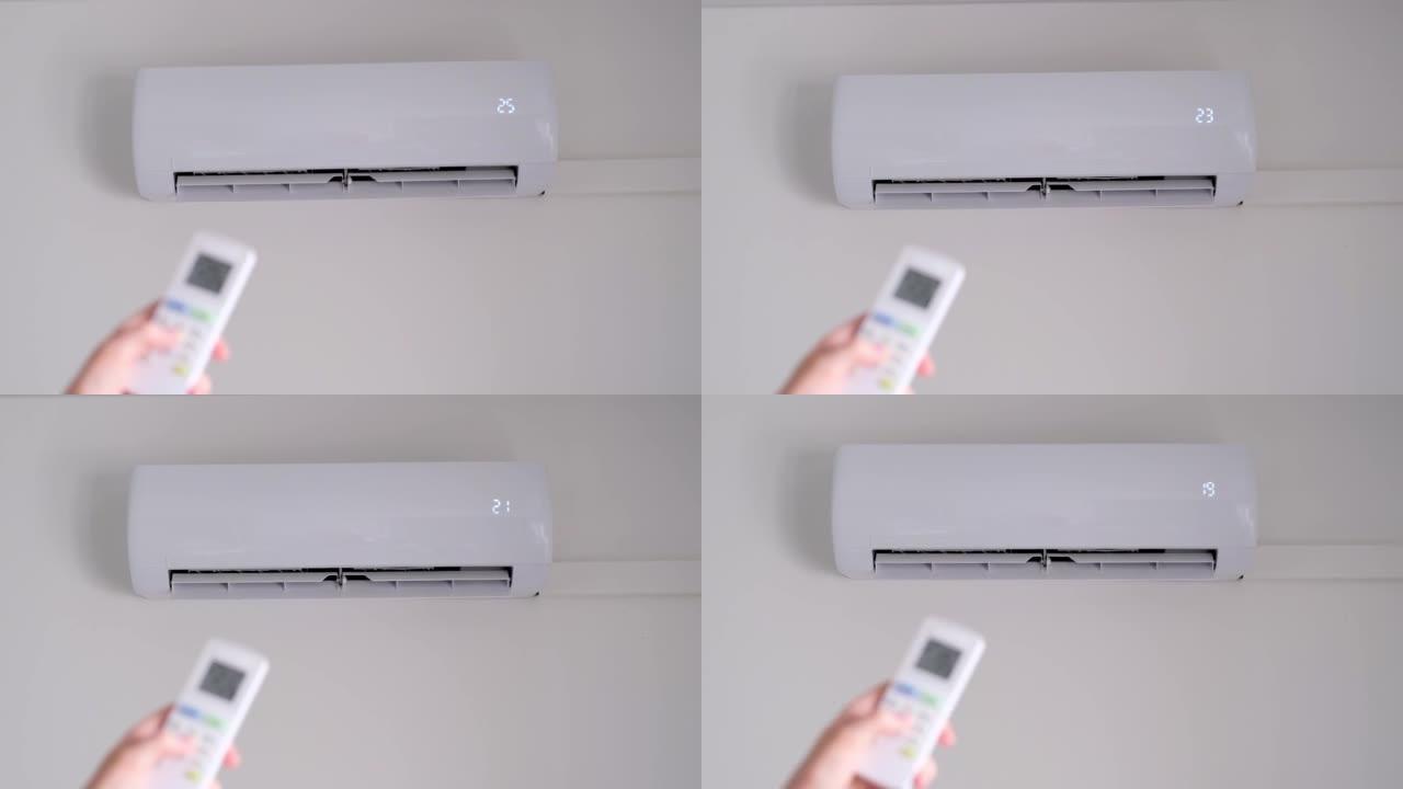 使用遥控器将空调温度降低到18度。现代空调技术。慢动作