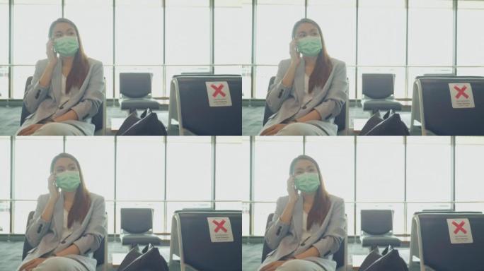 东南亚女商人在国际机场等待航班并使用智能手机