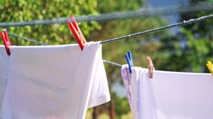 Wet Clothes and Towel Drying on Laundry Line in Ba