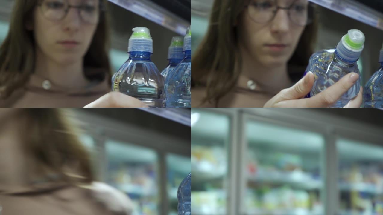 年轻女子在超市购买一瓶矿泉水