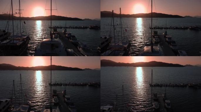 日落时被群山环绕的费蒂耶土耳其海湾的空中景观
