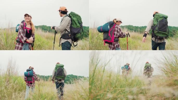 快乐的年轻夫妇徒步旅行者走过一片干燥的草地。年轻的男人和女人一起享受美好的时光。