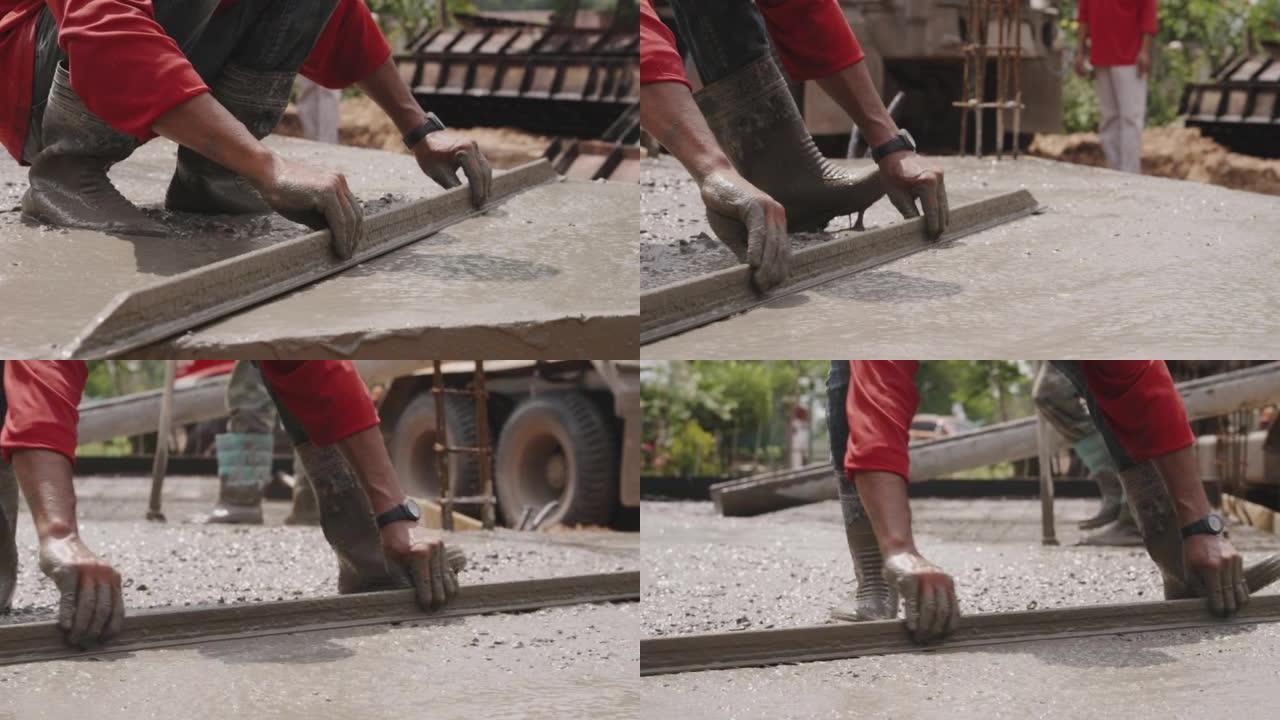 建筑工人在工地上建造找平层水泥地板。