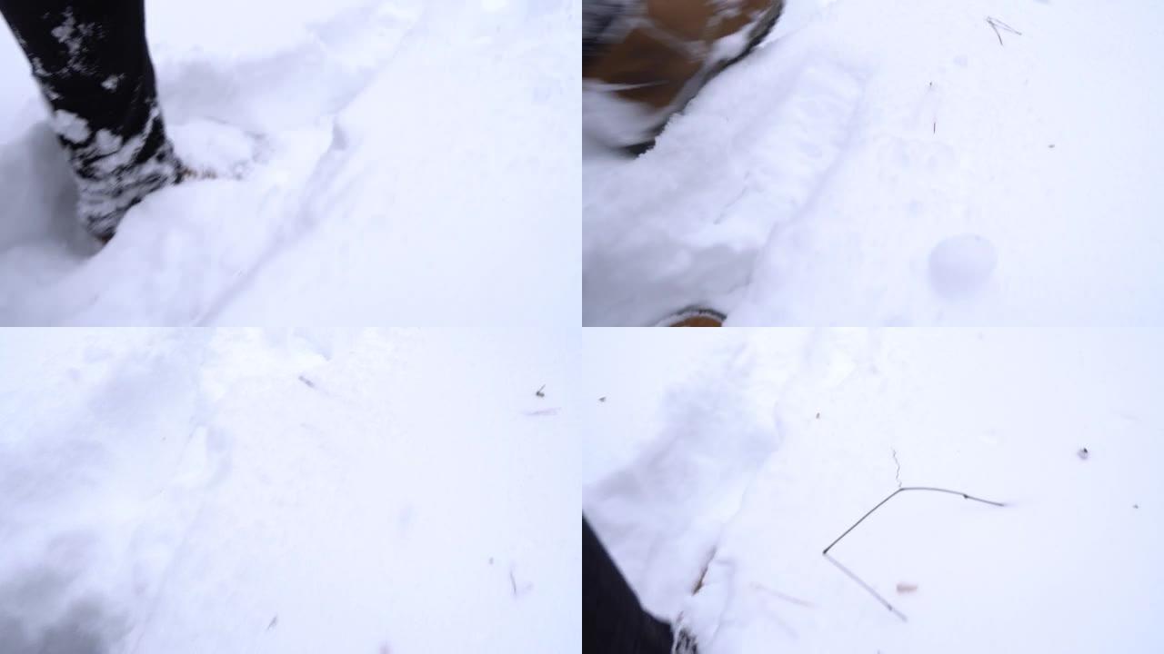 一个穿着棕色靴子的男人在冬天偷偷溜过雪堆