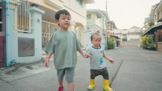 可爱的小男孩兄弟姐妹一起走在街上