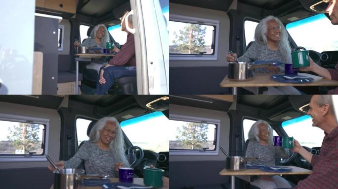 活跃的高级夫妇在定制的露营车中用餐