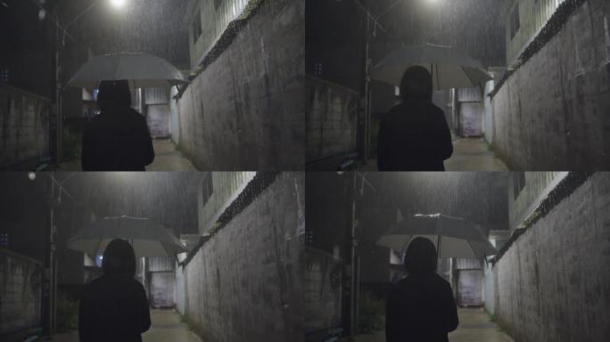 在下雨天，一名亚洲妇女独自站在一条小巷里。